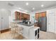 Modern kitchen with wood cabinets and dark appliances at 10211 Cleghorn Dr, San Antonio, FL 33576