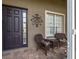 Front porch features two wicker chairs and a small table at 10211 Cleghorn Dr, San Antonio, FL 33576