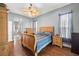 Large bedroom with wood flooring, ceiling fan, and ensuite bathroom access at 10211 Cleghorn Dr, San Antonio, FL 33576