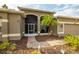 Front entrance with a screened porch, landscaping, and a paved walkway at 10211 Cleghorn Dr, San Antonio, FL 33576