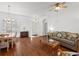 Living room with hardwood floors, a ceiling fan, and a comfortable sofa at 10211 Cleghorn Dr, San Antonio, FL 33576