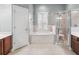 Primary bathroom with soaking tub, walk-in shower, and double vanity at 10211 Cleghorn Dr, San Antonio, FL 33576