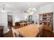 Spacious dining area with a wooden table and access to other rooms at 10211 Cleghorn Dr, San Antonio, FL 33576