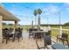 Covered patio with string lights and golf course views at 10211 Cleghorn Dr, San Antonio, FL 33576