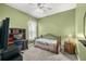 Cozy bedroom with a desk area, ceiling fan, and neutral wall color at 10211 Cleghorn Dr, San Antonio, FL 33576