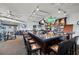 Community clubhouse bar with seating and large screen TV at 10211 Cleghorn Dr, San Antonio, FL 33576