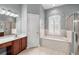 Primary bathroom features a large vanity, soaking tub, and walk-in shower at 10211 Cleghorn Dr, San Antonio, FL 33576