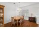 Charming dining room featuring wood floors and a chandelier at 10211 Cleghorn Dr, San Antonio, FL 33576