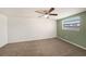 Spacious bedroom with neutral carpeting, and an accent wall at 3510 Allandale Dr, Holiday, FL 34691