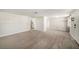 Bright living room with neutral walls and carpeting, showcasing a spacious and open layout at 3510 Allandale Dr, Holiday, FL 34691
