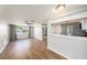 Spacious living area with wood-look floors, kitchen view, and access to backyard at 3510 Allandale Dr, Holiday, FL 34691