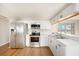 Modern kitchen with stainless steel appliances and white shaker cabinets at 3510 Allandale Dr, Holiday, FL 34691