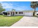 Newly renovated home with a covered porch and circular driveway at 3510 Allandale Dr, Holiday, FL 34691