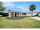 Newly renovated home with a covered porch, circular driveway and lush lawn at 3510 Allandale Dr, Holiday, FL 34691