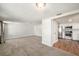 Open concept living room with view into kitchen, featuring light walls and wood-look flooring at 3510 Allandale Dr, Holiday, FL 34691