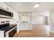 Updated kitchen, stainless steel appliances and white cabinets, open to the living area at 3510 Allandale Dr, Holiday, FL 34691