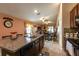 Open kitchen with island and breakfast bar overlooking living area at 417 Serenity Mill Loop, Ruskin, FL 33570