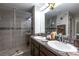 Elegant bathroom with double vanity, large mirror, and glass shower at 417 Serenity Mill Loop, Ruskin, FL 33570