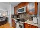 Modern kitchen with granite countertops and rich wood cabinetry at 18593 Bridle Club Dr, Tampa, FL 33647