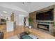Living area with a stone fireplace and large TV at 18593 Bridle Club Dr, Tampa, FL 33647