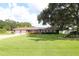 Ranch-style brick home with a large yard and mature oak tree at 5302 Turkey Creek Rd, Plant City, FL 33567