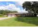 Brick ranch home with two-car garage and mature landscaping at 5302 Turkey Creek Rd, Plant City, FL 33567