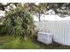 Generac generator in backyard with lush landscaping and white fence at 5302 Turkey Creek Rd, Plant City, FL 33567