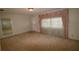 Bright living room featuring carpet floors and a window with curtains at 5302 Turkey Creek Rd, Plant City, FL 33567