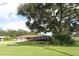 Ranch-style brick home with a large yard and mature oak tree at 5302 Turkey Creek Rd, Plant City, FL 33567