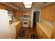 Kitchen with wood cabinets, white appliances, and a laminate countertop at 5302 Turkey Creek Rd, Plant City, FL 33567