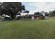 Spacious backyard with detached garage and large lawn area at 5302 Turkey Creek Rd, Plant City, FL 33567