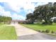 Ranch-style brick home with a large yard and mature oak tree at 5302 Turkey Creek Rd, Plant City, FL 33567
