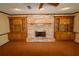 Living room with a brick fireplace and wooden built-ins at 5302 Turkey Creek Rd, Plant City, FL 33567
