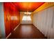 Dining room with wood paneling, hardwood floors, and sheer curtains at 5302 Turkey Creek Rd, Plant City, FL 33567