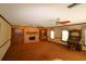Living room with brick fireplace, built-in shelving, and ceiling fans at 5302 Turkey Creek Rd, Plant City, FL 33567