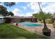 Relaxing kidney-shaped pool with brick patio, lush landscaping, and screened porch at 5302 Turkey Creek Rd, Plant City, FL 33567