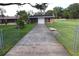 Private gated driveway to detached garage; backyard with pool is visible at 5302 Turkey Creek Rd, Plant City, FL 33567