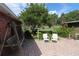 Brick patio with a wooden swing, chairs, and lush landscaping at 5302 Turkey Creek Rd, Plant City, FL 33567