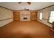 Spacious living room featuring a brick fireplace and built-in shelving at 5302 Turkey Creek Rd, Plant City, FL 33567