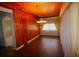 Dining room with wood paneling, hardwood floors, and sheer curtains at 5302 Turkey Creek Rd, Plant City, FL 33567