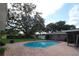 Refreshing blue pool with brick patio, large oak tree, and ample yard space at 5302 Turkey Creek Rd, Plant City, FL 33567