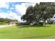 Brick ranch home with a large oak tree and expansive lawn at 5302 Turkey Creek Rd, Plant City, FL 33567