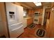 Kitchen with wood cabinets, white appliances, and laminate countertops at 5302 Turkey Creek Rd, Plant City, FL 33567