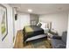 Main bedroom featuring a queen bed and light wood floors at 1923 E Henry St, Tampa, FL 33610