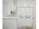 Main bathroom with shower, toilet and white cabinets at 17399 Nectar Flume Dr, Land O Lakes, FL 34638