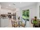 Bright kitchen with glass-top table and sliding door to backyard at 17399 Nectar Flume Dr, Land O Lakes, FL 34638