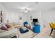 Open living room with sectional sofa, two armchairs and a large TV at 17399 Nectar Flume Dr, Land O Lakes, FL 34638