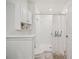 Clean bathroom with shower, toilet and white cabinets at 17399 Nectar Flume Dr, Land O Lakes, FL 34638