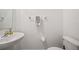 Small half bathroom with pedestal sink and toilet at 17399 Nectar Flume Dr, Land O Lakes, FL 34638