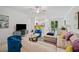 Open living room with sectional sofa, stylish decor, and a view into the kitchen at 17399 Nectar Flume Dr, Land O Lakes, FL 34638